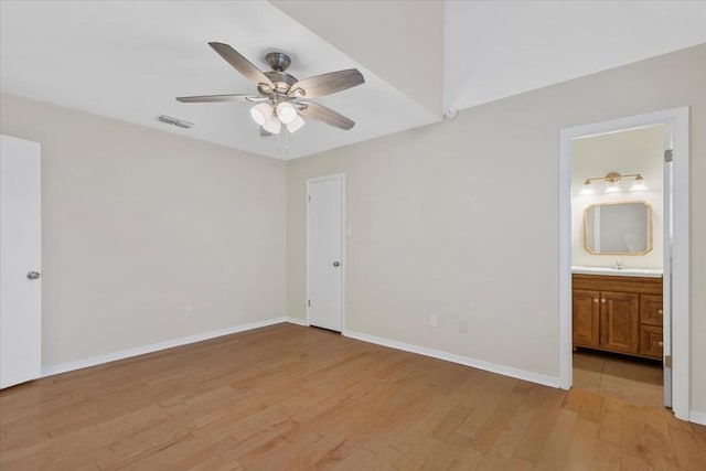3959 Fm 535, Bastrop, TX 78602 - unfurnished bedroom with light wood-type flooring, connected bathroom, and ceiling fan
