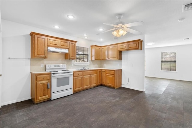 3959 Fm 535, Bastrop, TX 78602 - kitchen with electric stove, under cabinet range hood, a ceiling fan, light countertops, and recessed lighting