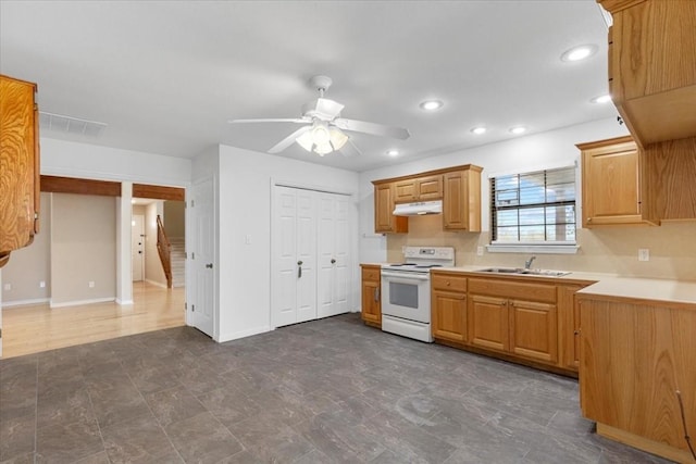 3959 Fm 535, Bastrop, TX 78602 - kitchen with electric range, light countertops, a ceiling fan, under cabinet range hood, and recessed lighting