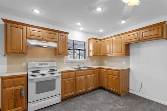 3959 Fm 535, Bastrop, TX 78602 - kitchen with under cabinet range hood, white range with electric cooktop, light countertops, brown cabinets, and recessed lighting