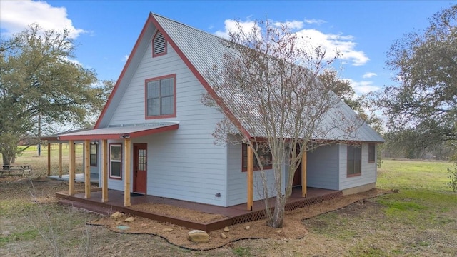 exterior space with covered porch and a lawn