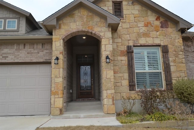 doorway to property with a garage