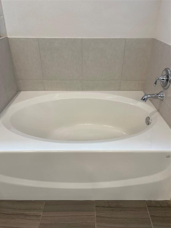 bathroom with a tub to relax in