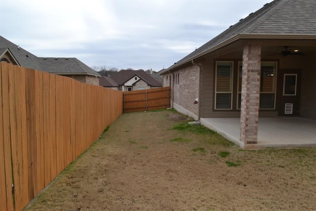 view of yard with ceiling fan and a patio area