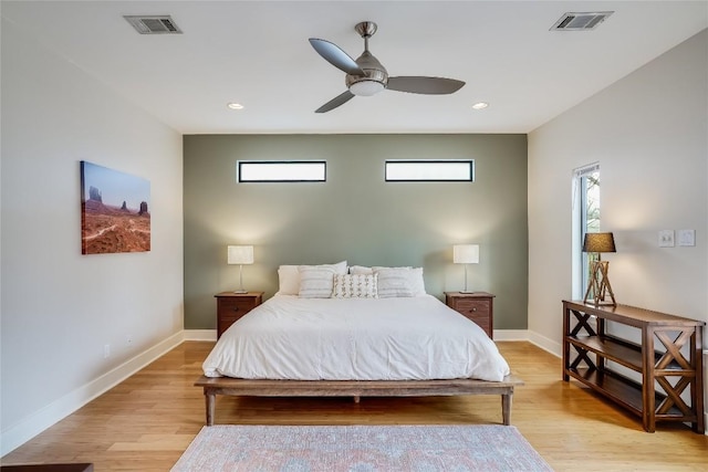 1109 Holly St Unit B, Austin, TX 78702 - bedroom with multiple windows, light wood-type flooring, baseboards, ceiling fan, and recessed lighting