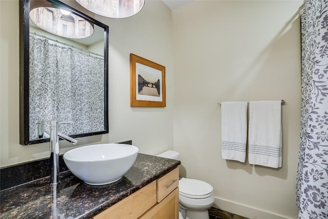 bathroom featuring vanity and toilet