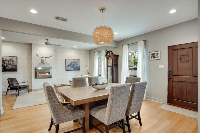 1109 Holly St Unit B, Austin, TX 78702 - dining room featuring light wood-type flooring, baseboards, a ceiling fan, recessed lighting, and wallpapered walls
