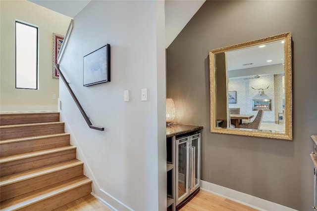 1109 Holly St Unit B, Austin, TX 78702 - stairs featuring beverage cooler, wood finished floors, a bar, and baseboards