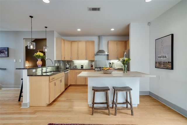1109 Holly St Unit B, Austin, TX 78702 - kitchen featuring wall chimney exhaust hood, light brown cabinetry, dishwasher, a kitchen bar, and a sink