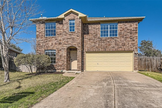 traditional-style home with brick siding, concrete driveway, an attached garage, fence, and a front lawn