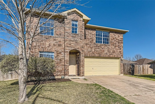 traditional-style home with brick siding, concrete driveway, an attached garage, fence, and a front yard