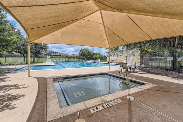 pool featuring fence and a patio