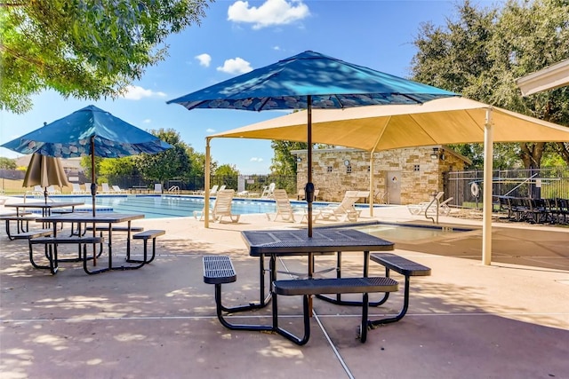 surrounding community with a pool, fence, and a patio