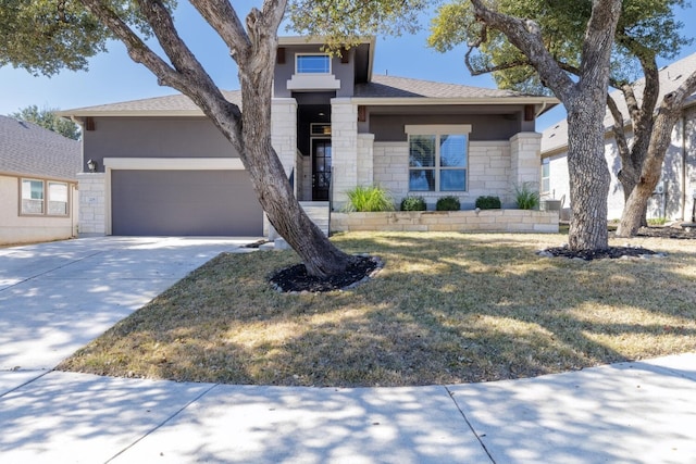 view of front of home featuring a garage and a front yard