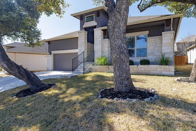 view of front of house with a garage and a front lawn