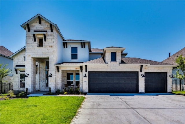 view of front of home with a garage and a front lawn