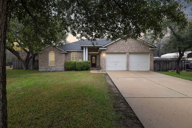 ranch-style house featuring a yard and a garage