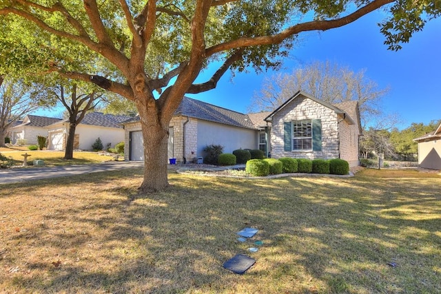 ranch-style house with a garage and a front lawn