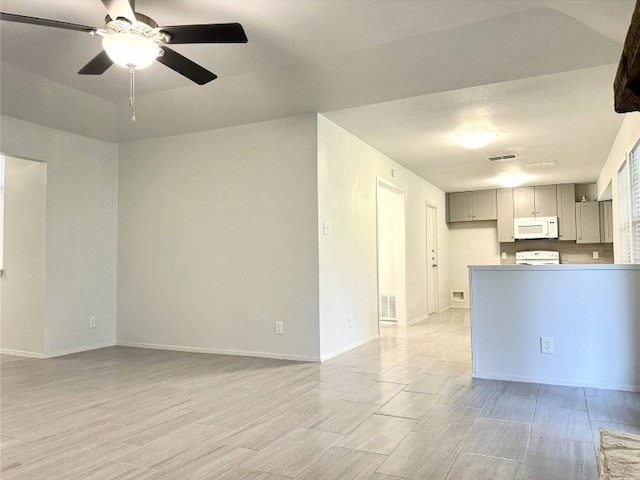 12104 Sage Hen Cir, Austin, TX 78727 - unfurnished living room featuring light wood-style flooring and ceiling fan