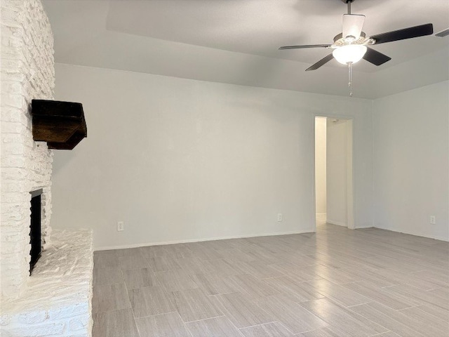 12104 Sage Hen Cir, Austin, TX 78727 - unfurnished living room with a ceiling fan, a fireplace with raised hearth, and wood finish floors