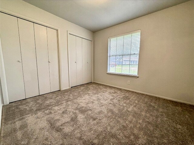 12104 Sage Hen Cir, Austin, TX 78727 - unfurnished bedroom with multiple closets and carpet flooring