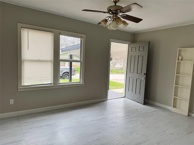 foyer entrance featuring crown molding and ceiling fan