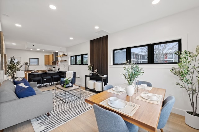 dining space featuring sink and light hardwood / wood-style floors