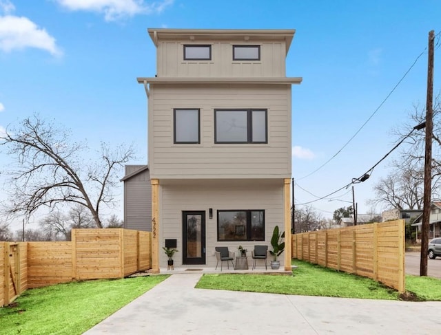 back of property with a patio area and a lawn