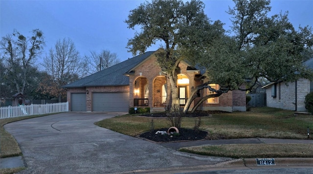 view of front facade featuring a garage and a yard