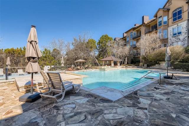 view of pool featuring a gazebo, pool water feature, and a patio