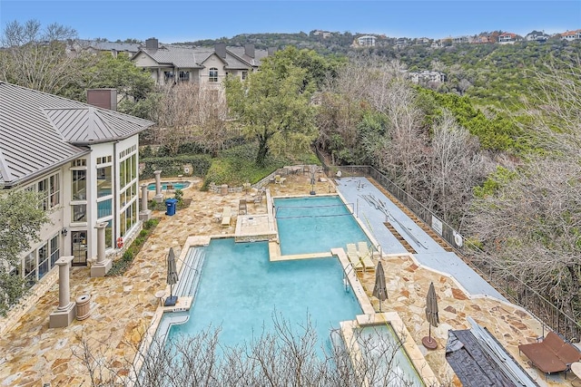 view of swimming pool with pool water feature and a patio area