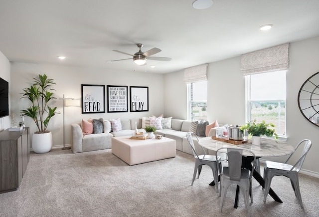 carpeted living room with ceiling fan