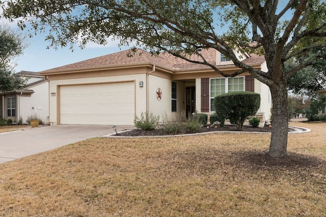 ranch-style home with a garage and a front lawn