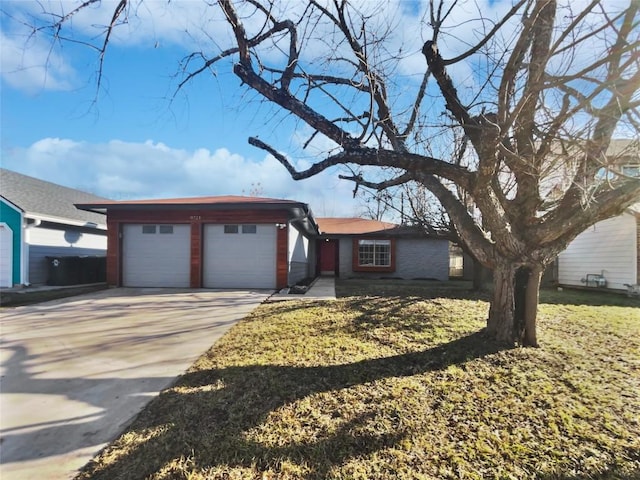 view of front facade with a front yard and a garage