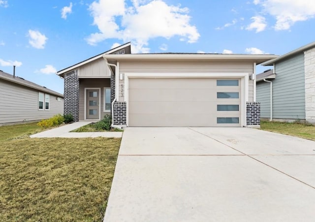 view of front of home with a garage and a front lawn