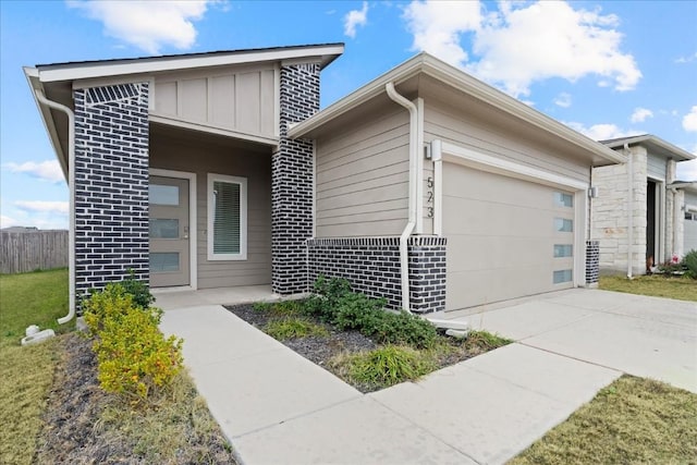 view of front of house with board and batten siding, concrete driveway, and a garage