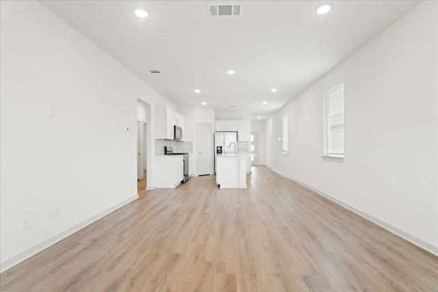 unfurnished living room featuring light wood-type flooring