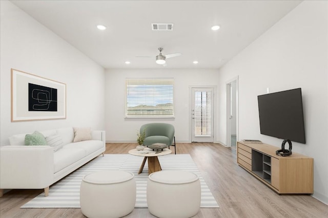 living room featuring ceiling fan and light wood-type flooring