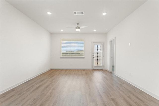 spare room featuring ceiling fan and light wood-type flooring