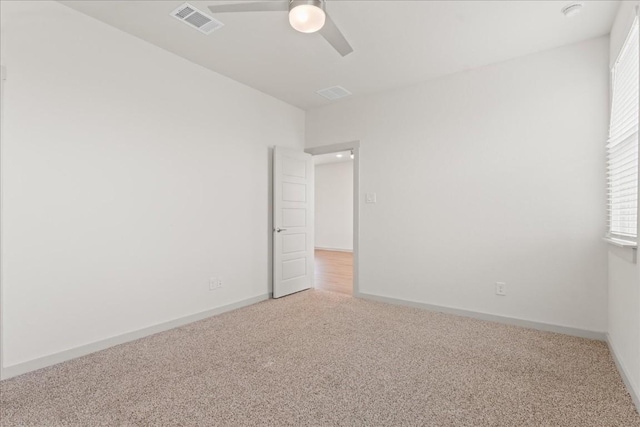 carpeted empty room featuring ceiling fan