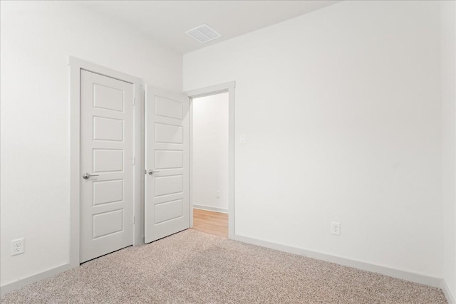 spare room with light colored carpet