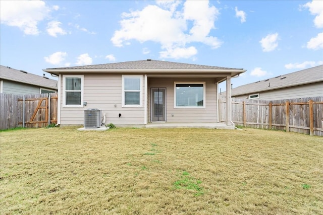 back of property featuring central AC, a lawn, and a patio area