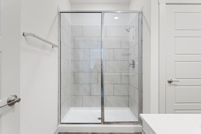 bathroom featuring a shower with shower door