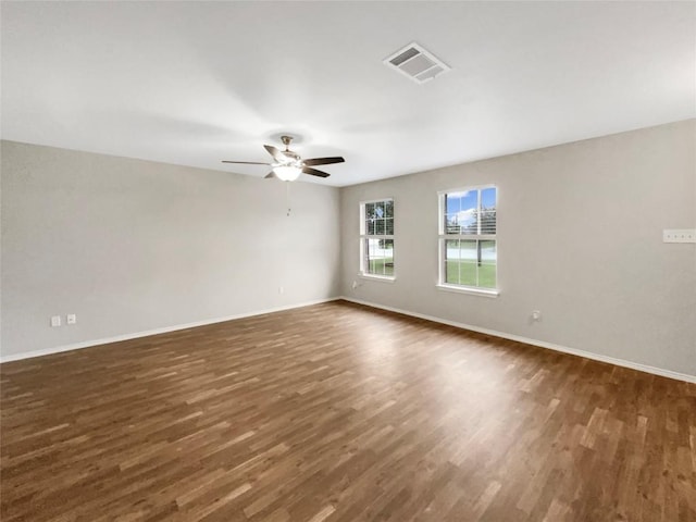 empty room with dark hardwood / wood-style floors and ceiling fan