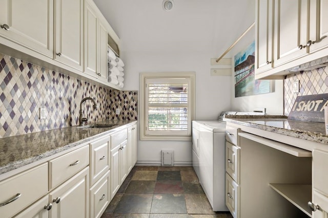 washroom with sink, separate washer and dryer, and cabinets