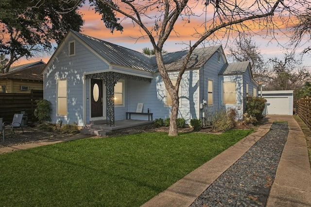 906 E 43rd St, Austin, TX 78751 - view of front of property with a metal roof, a porch, driveway, and a detached garage