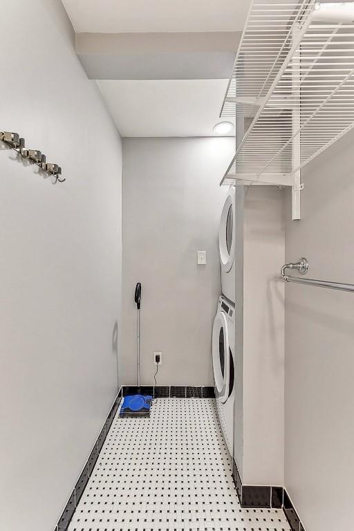 906 E 43rd St, Austin, TX 78751 - laundry area featuring estacked washer and dryer and light floors