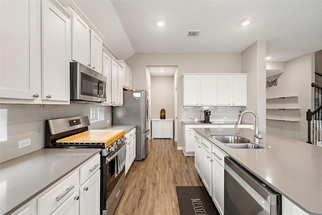 kitchen featuring white cabinetry, appliances with stainless steel finishes, and sink