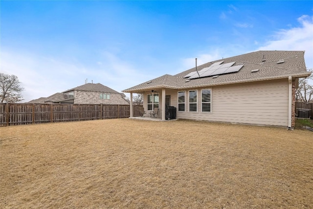 back of house featuring a patio and solar panels