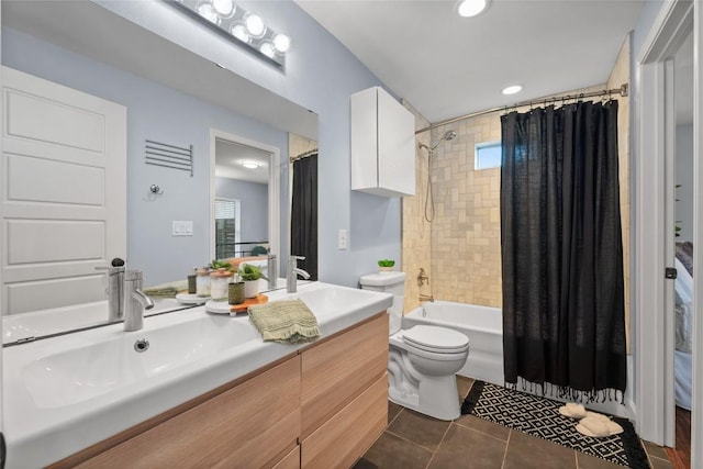 full bathroom featuring tile patterned floors, toilet, vanity, shower / bath combo with shower curtain, and a wealth of natural light